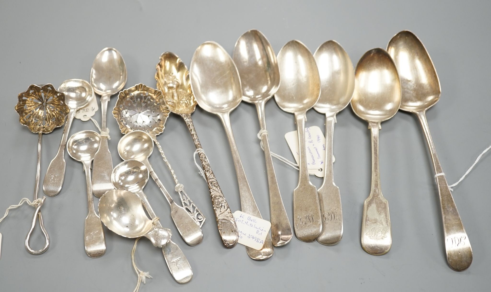 A small collection of 18th century and later silver flatware, including a table spoon by Thomas Eustace, Exeter, 1785, two 18th century silver lace back dessert spoons, an 18th century 'berry' spoon, a George III silver